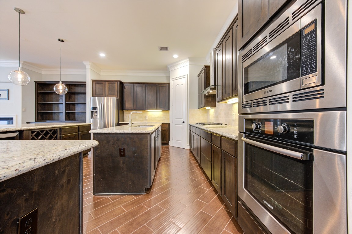 5226 Kiam Street, Unit 1015 Houston, TX 77007 - Photo 29 of 49 a kitchen with stainless steel appliances granite countertop a stove a sink and a refrigerator
