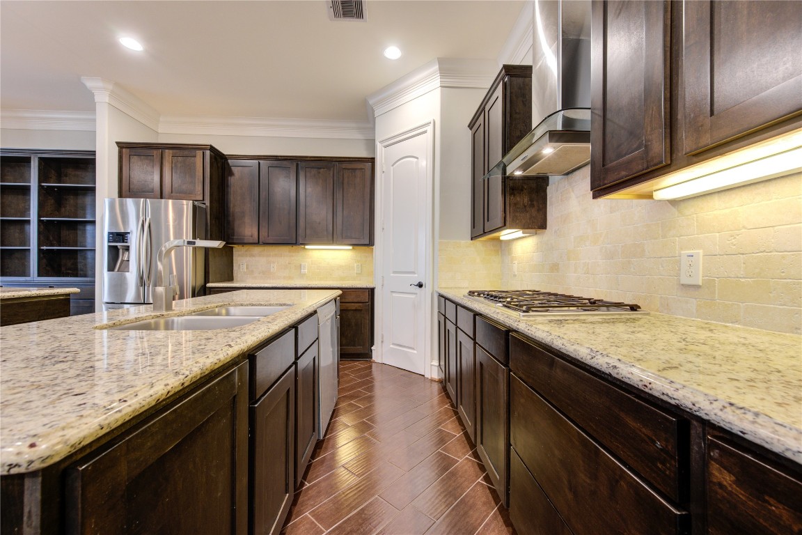 5226 Kiam Street, Unit 1015 Houston, TX 77007 - Photo 30 of 49 a kitchen with stainless steel appliances granite countertop a sink counter space cabinets and stove