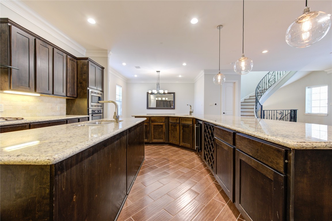 5226 Kiam Street, Unit 1015 Houston, TX 77007 - Photo 33 of 49 a large kitchen with a large counter top a sink a window and stainless steel appliances