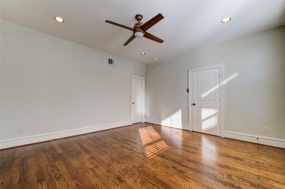 5226 Kiam Street, Unit 1015 Houston, TX 77007 - Photo 39 of 49 an empty room with wooden floor ceiling fan and windows