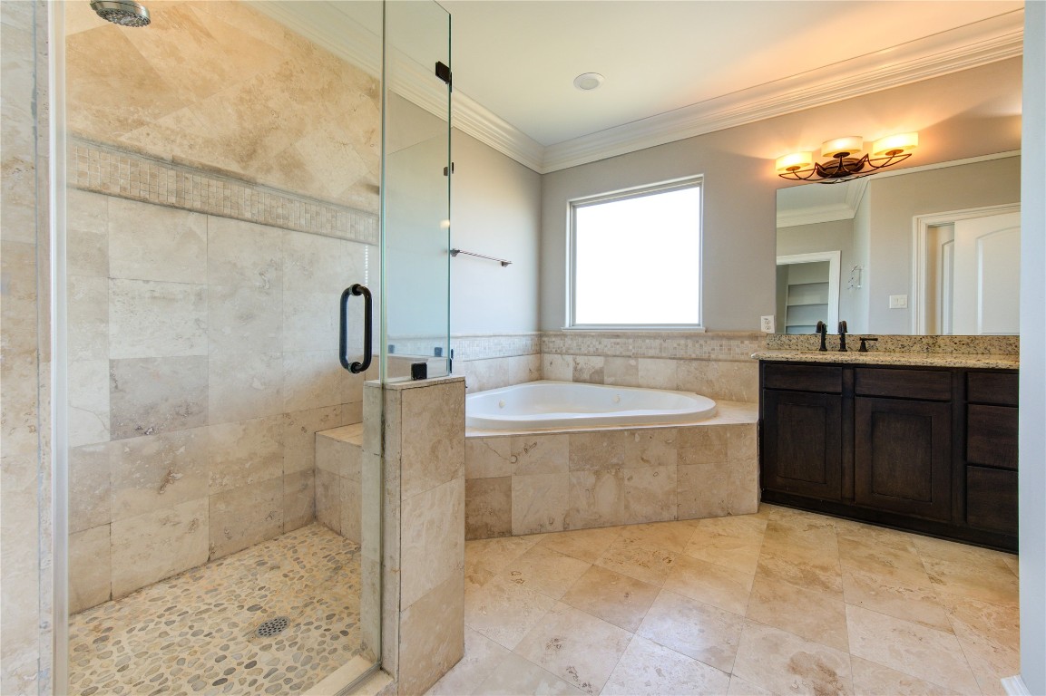 5226 Kiam Street, Unit 1015 Houston, TX 77007 - Photo 45 of 49 a bathroom with a granite countertop sink a mirror and a bathtub