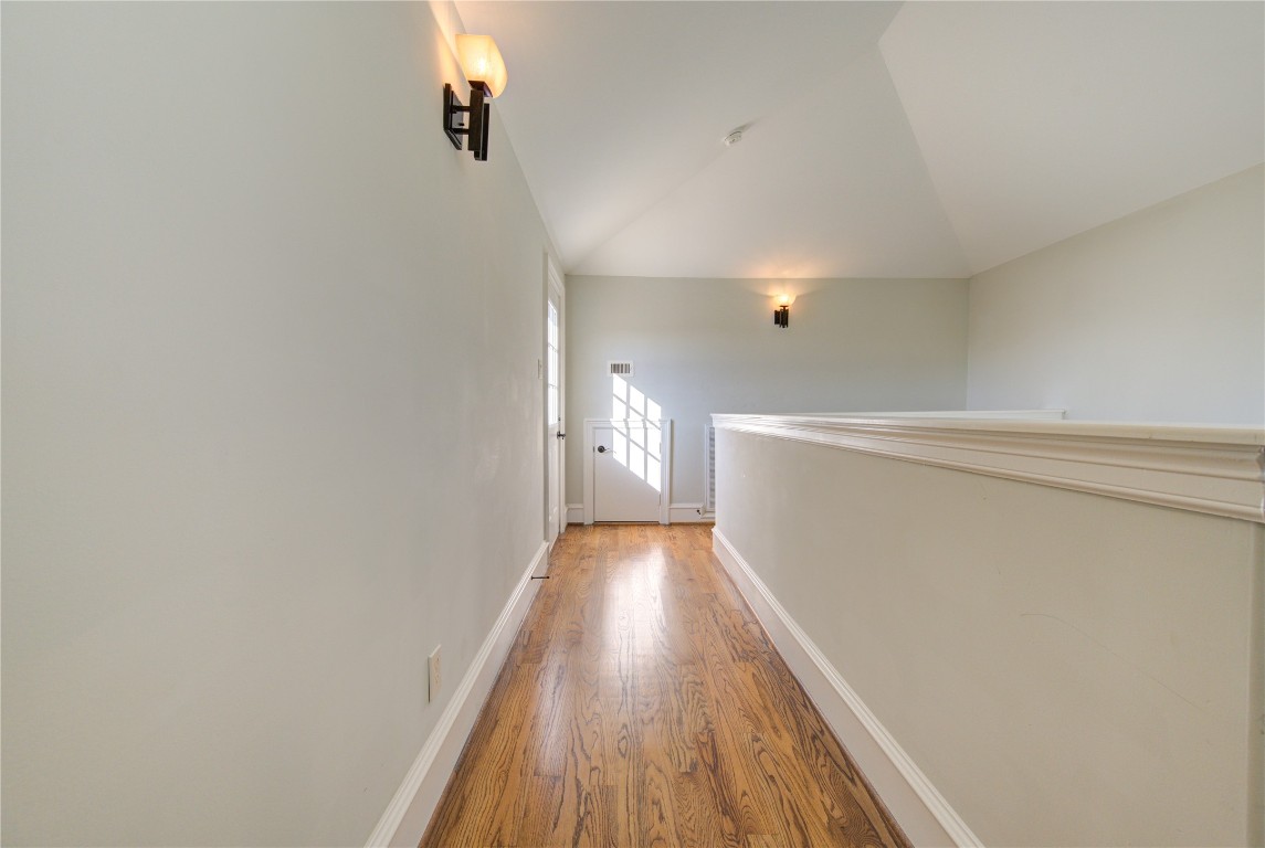 5226 Kiam Street, Unit 1015 Houston, TX 77007 - Photo 47 of 49 a view of a hallway with wooden floor