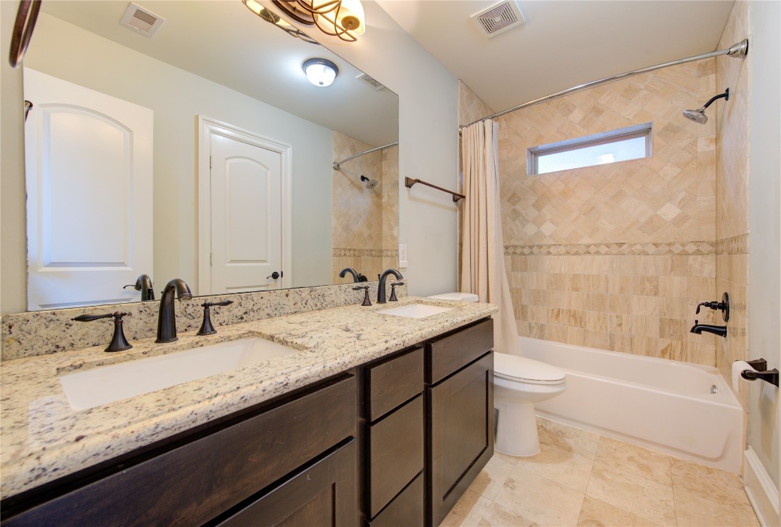 5226 Kiam Street, Unit 1015 Houston, TX 77007 - Photo 9 of 49 a bathroom with a granite countertop sink mirror toilet and bathtub