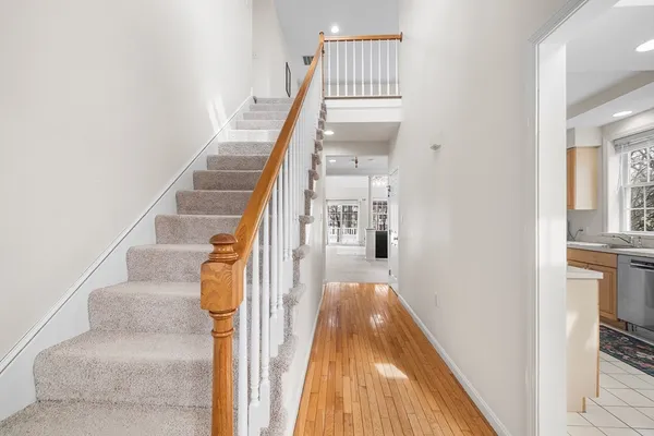 a view of entryway and hall with wooden floor