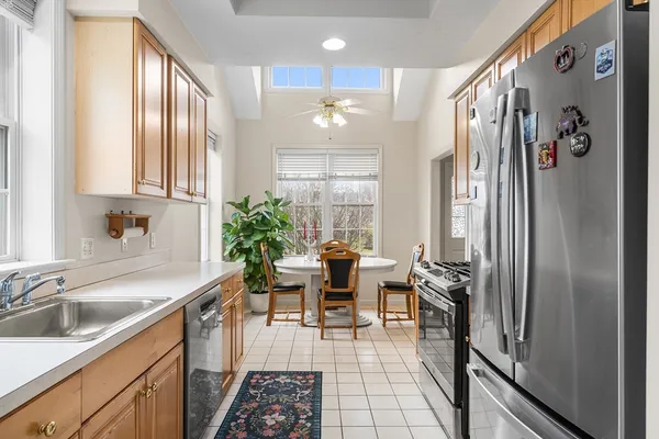 a kitchen with granite countertop a sink stainless steel appliances and cabinets