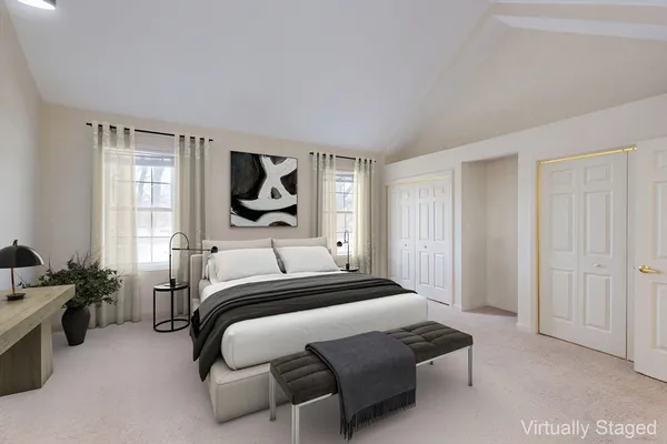 a bedroom with a bed couch and window