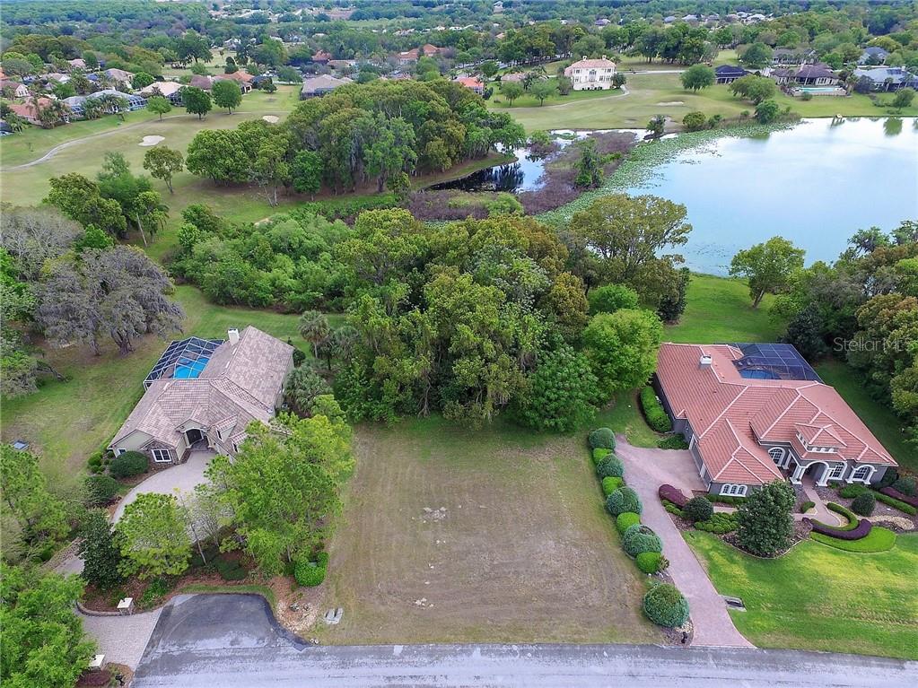 an aerial view of lake residential houses with outdoor space and lake view