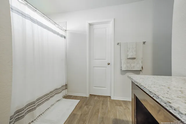 a view of bathroom with granite countertop sink