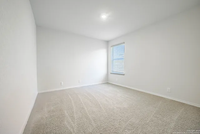 an empty room with a empty space and windows