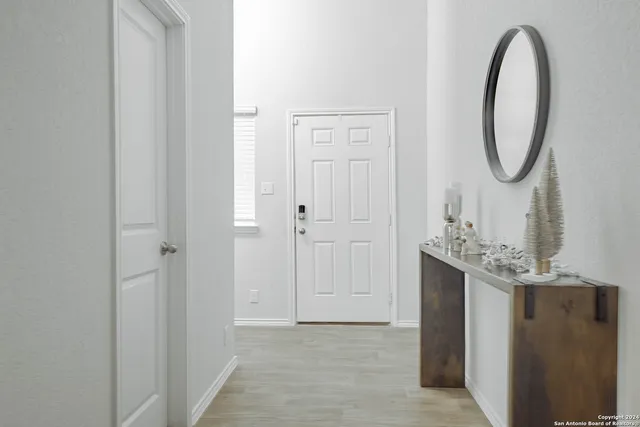 a view of a mirror light fixtures and entryway