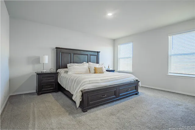 a spacious bedroom with a bed and a window