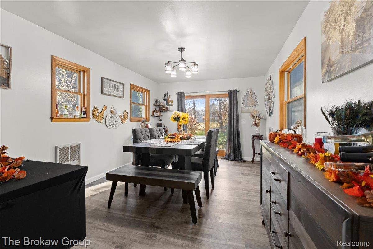 10490 Green Road Goodrich, MI 48438 - Photo 21 of 51 Dining space featuring light wood-type flooring, healthy amount of natural light, and a chandelier