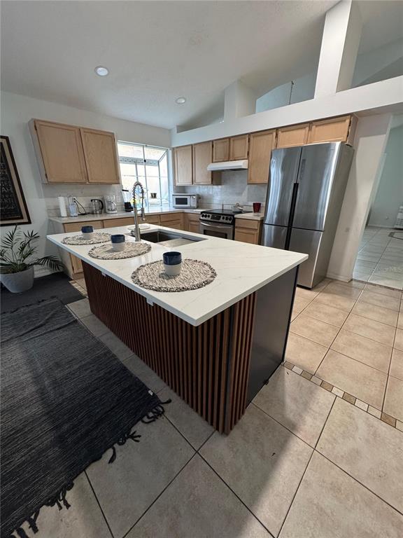 2512 Asbury Court Kissimmee, FL 34746 - Photo 11 of 12 a kitchen with stainless steel appliances granite countertop a stove a sink a refrigerator and a refrigerator