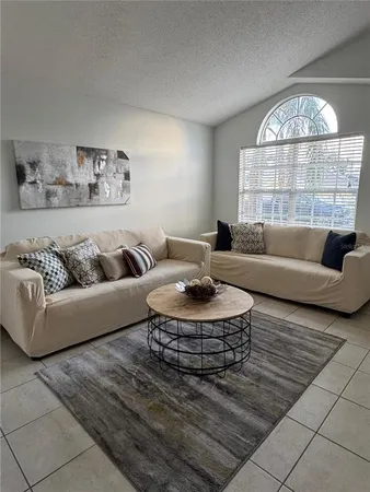 a living room with furniture and a large window