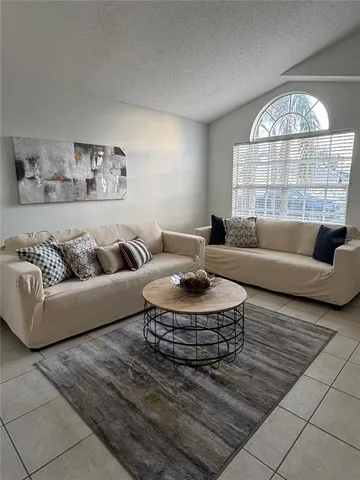 a living room with furniture and a large window