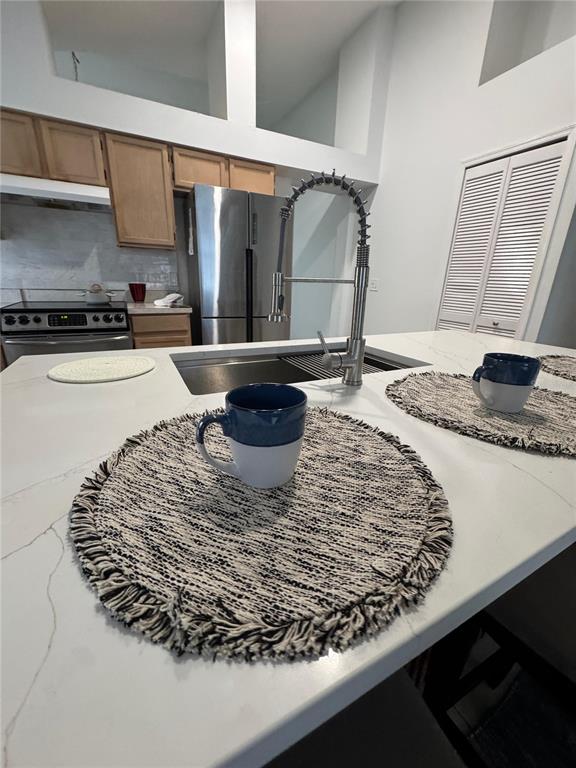 2512 Asbury Court Kissimmee, FL 34746 - Photo 10 of 12 a kitchen with a stove and a sink