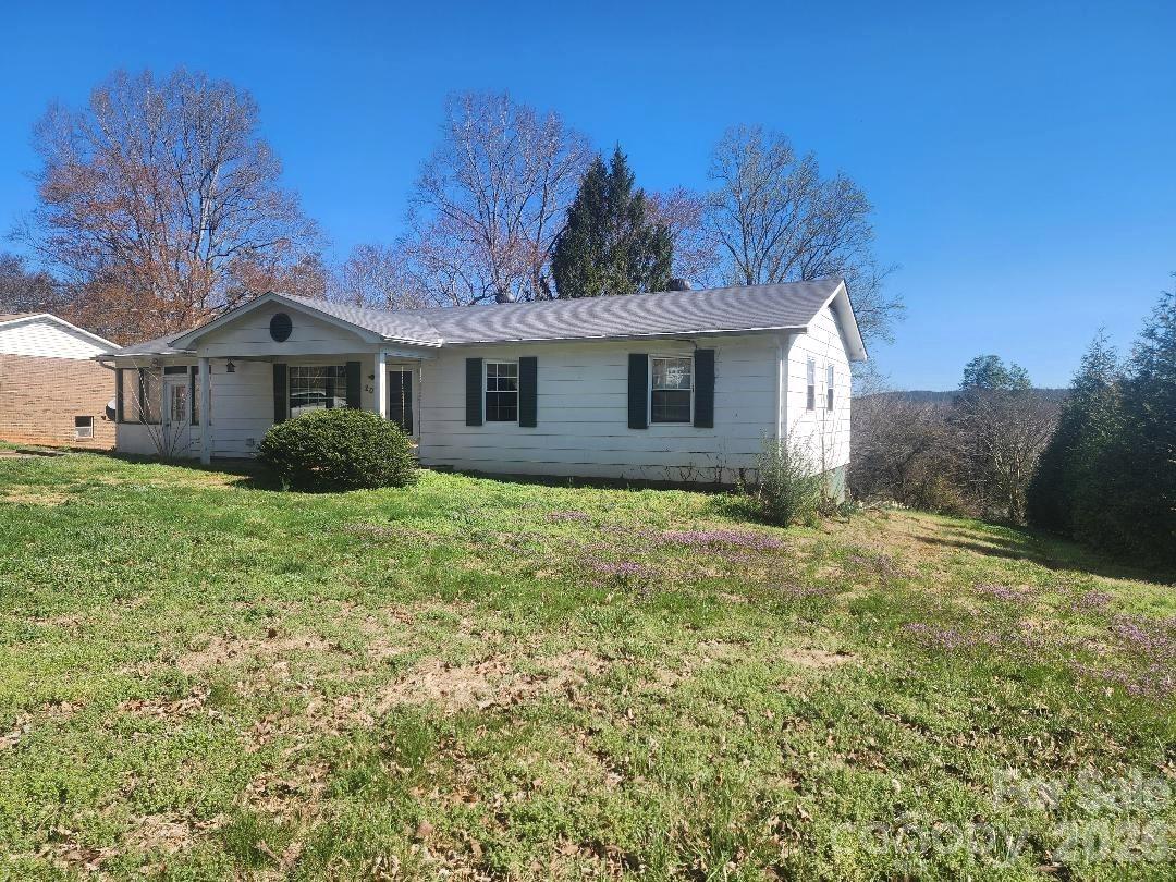 203 Brentwood Road, Unit 61 Morganton, NC 28655 - Photo 1 of 11 a view of a yard in front of a house with large windows