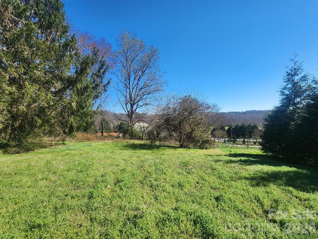 203 Brentwood Road, Unit 61 Morganton, NC 28655 - Photo 9 of 11 a view of a grassy field with trees in the background