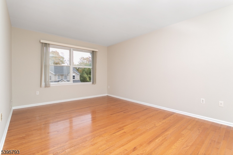 58 Autumn Ridge Road Morris Plains, NJ 07950 - Photo 14 of 30 an empty room with wooden floor and windows