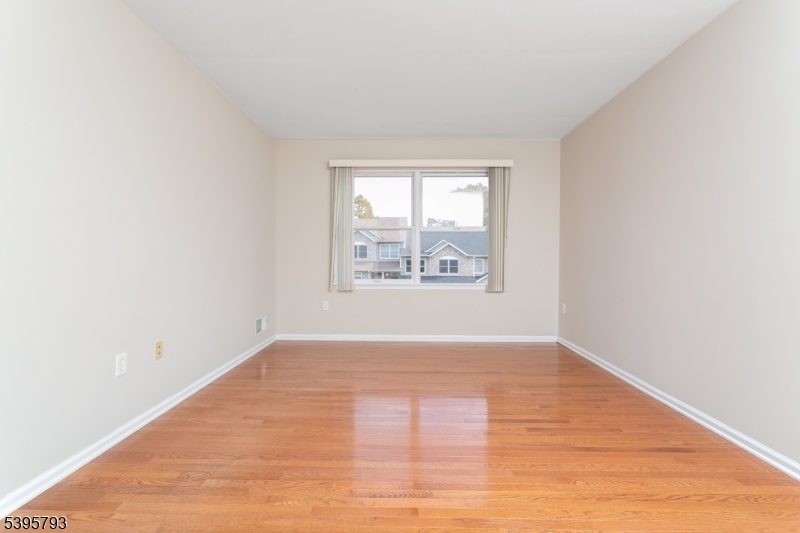58 Autumn Ridge Road Morris Plains, NJ 07950 - Photo 15 of 30 an empty room with wooden floor and windows