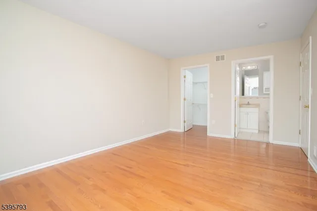 a view of an empty room and wooden floor