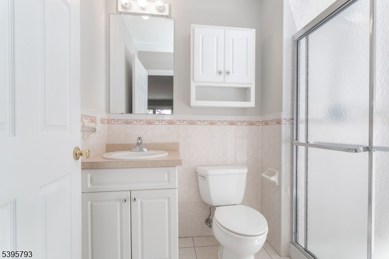 58 Autumn Ridge Road Morris Plains, NJ 07950 - Photo 17 of 30 a bathroom with a toilet a sink and mirror