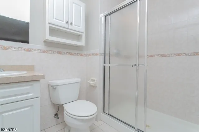 a white toilet sitting next to a bathroom