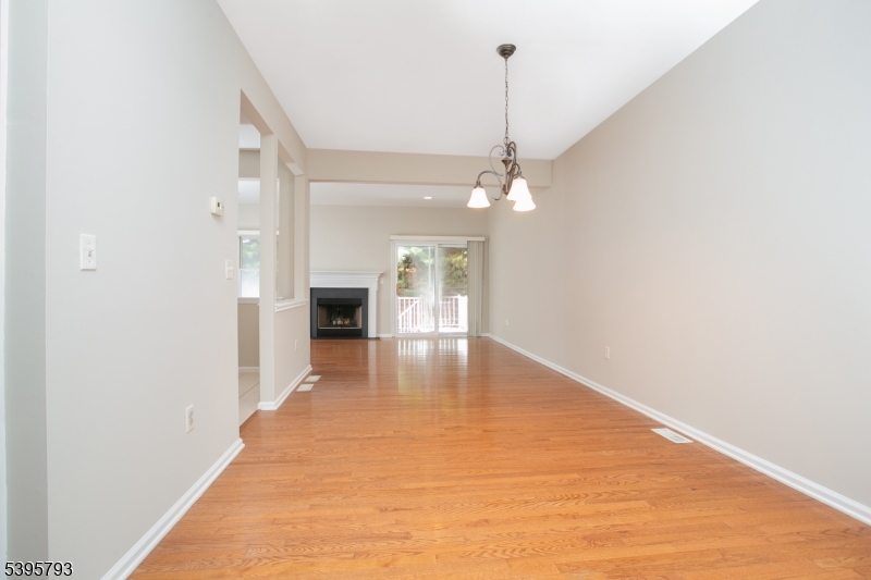 58 Autumn Ridge Road Morris Plains, NJ 07950 - Photo 2 of 30 a view of a hallway with wooden floor and a chandelier