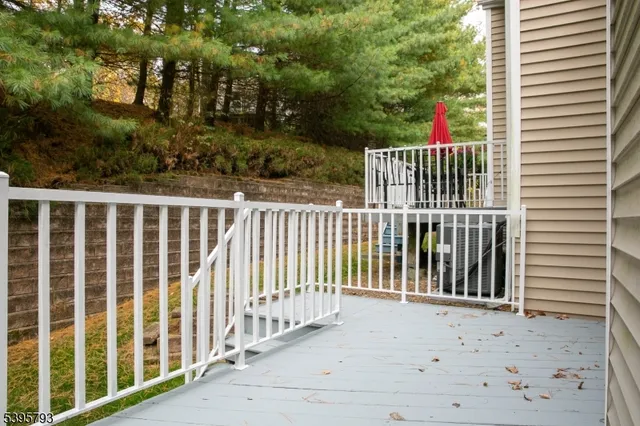 a view of a house with a small yard and wooden fence