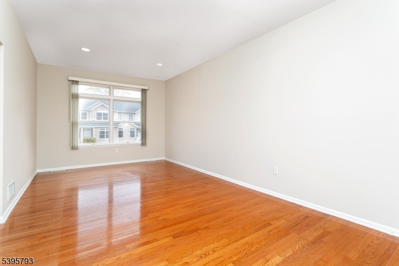58 Autumn Ridge Road Morris Plains, NJ 07950 - Photo 3 of 30 an empty room with wooden floor and windows