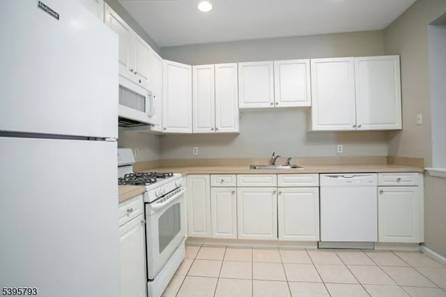 a kitchen with white cabinets