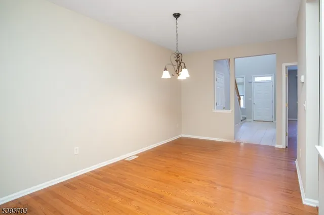 a view of an empty room with a chandelier