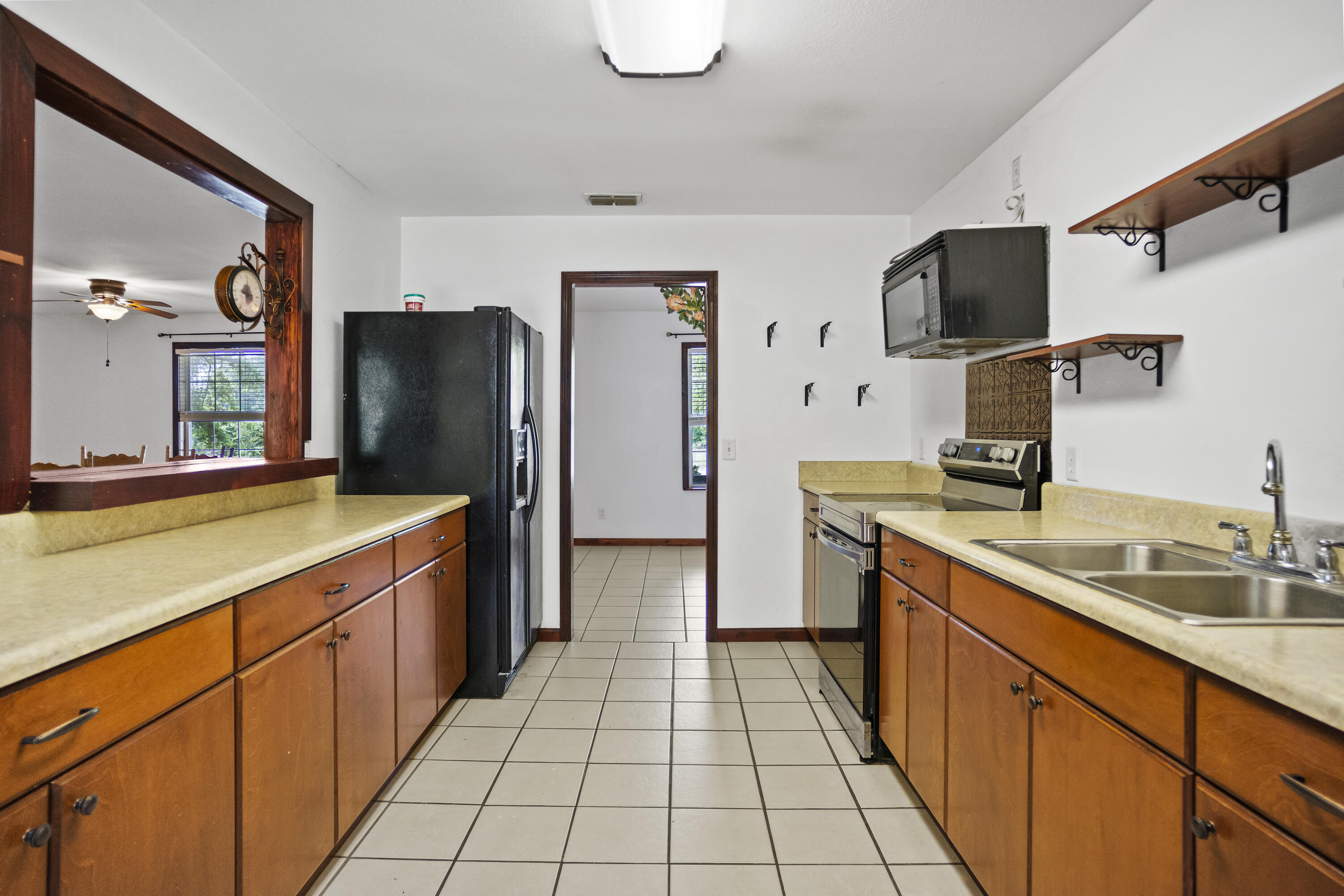 15766 Northeast Bob Sanders Road Hosford, FL 32334 - Photo 11 of 33 a kitchen with stainless steel appliances granite countertop a sink stove and refrigerator