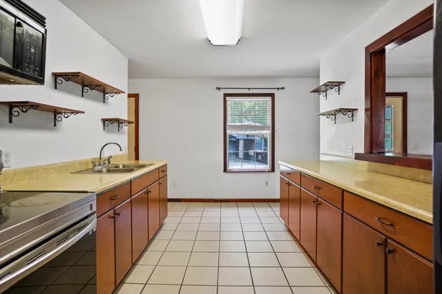 a view of a kitchen with a sink and cabinets