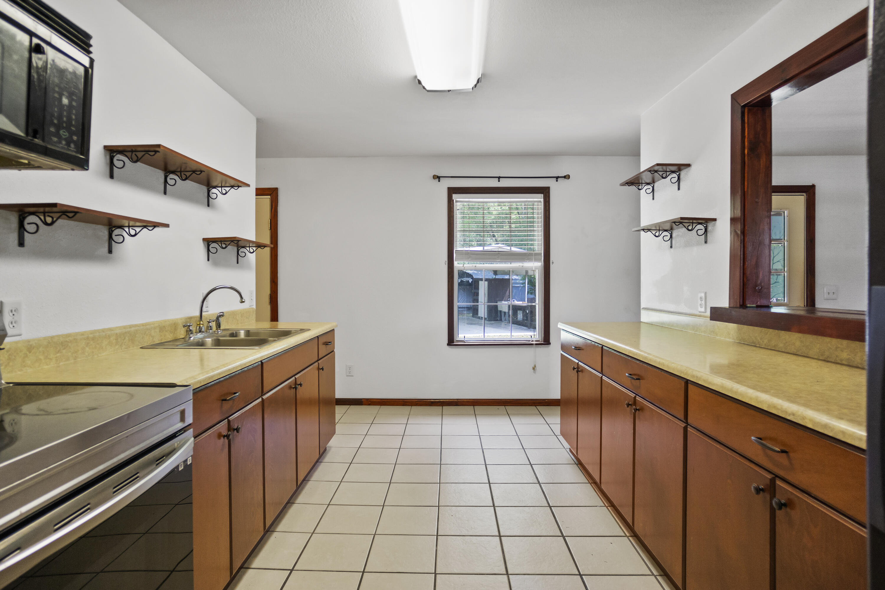 15766 Northeast Bob Sanders Road Hosford, FL 32334 - Photo 12 of 33 a view of a kitchen with a sink and cabinets