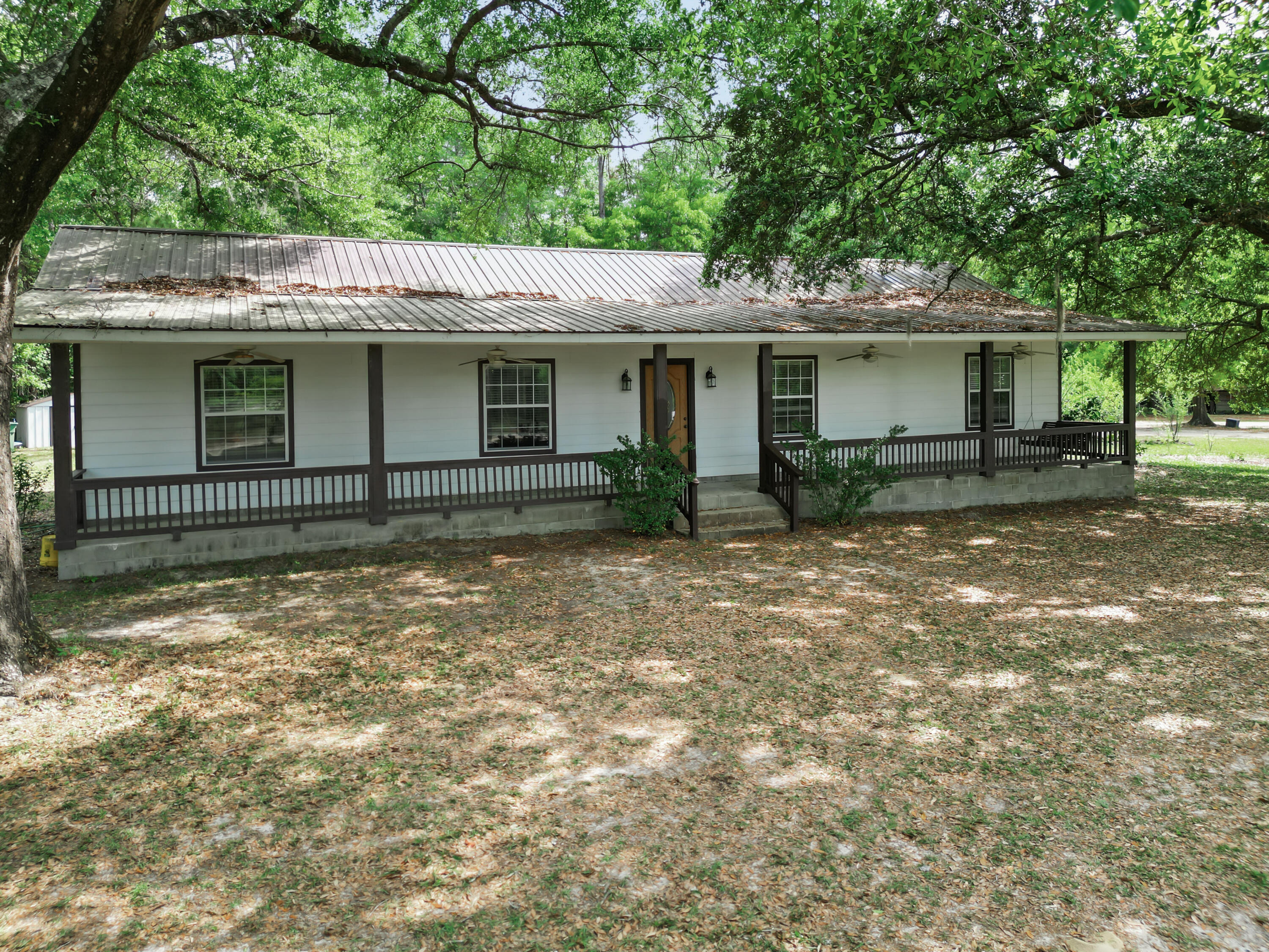 15766 Northeast Bob Sanders Road Hosford, FL 32334 - Photo 2 of 33 a view of a house with a yard and large tree