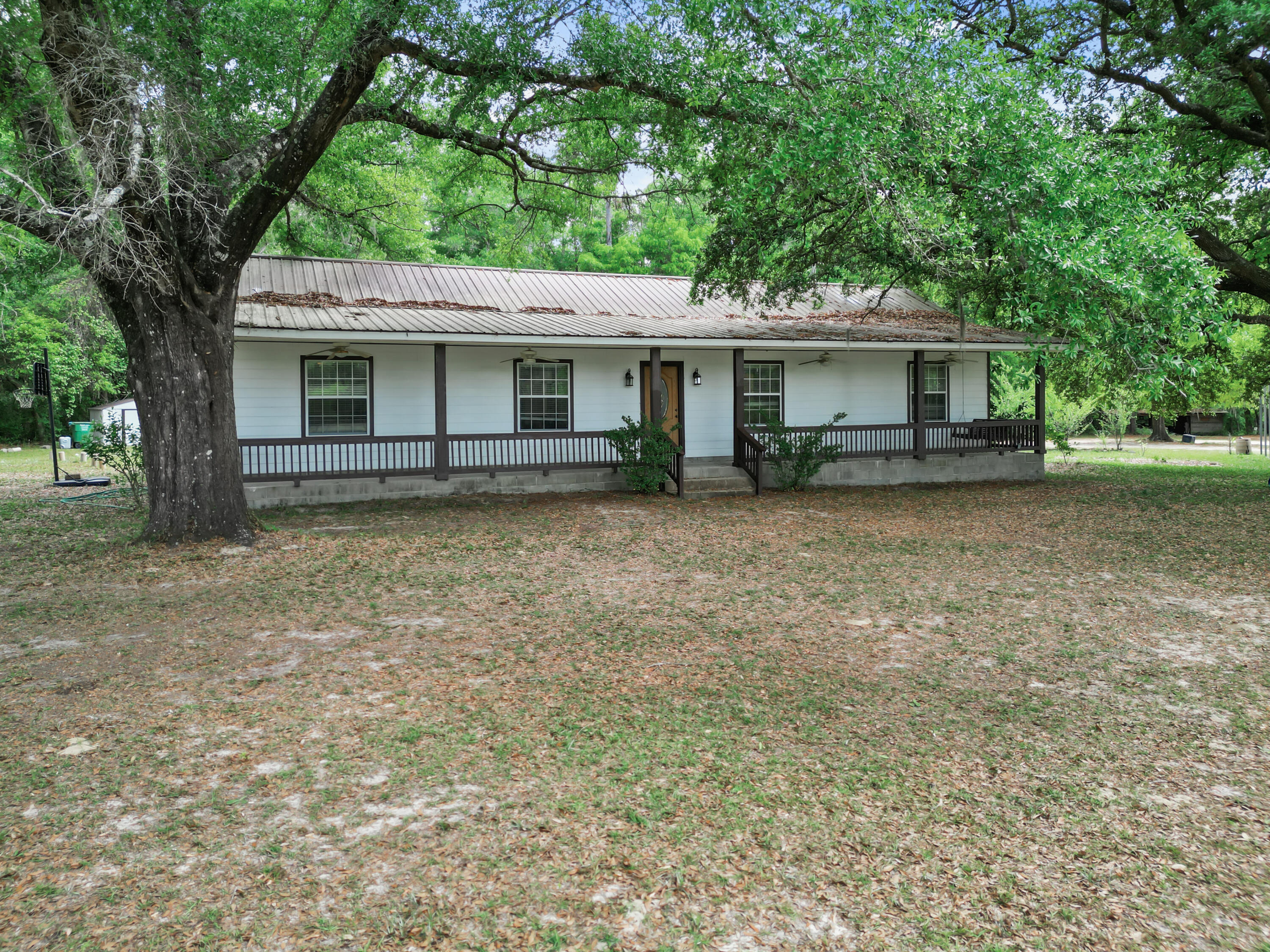 15766 Northeast Bob Sanders Road Hosford, FL 32334 - Photo 22 of 33 front view of a house with a trees