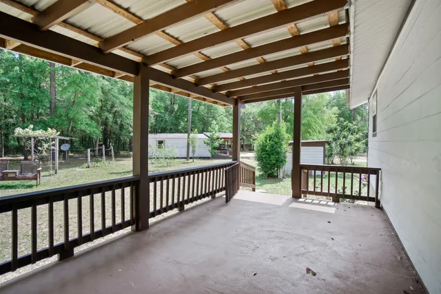 a view of a chair and table in backyard of the house