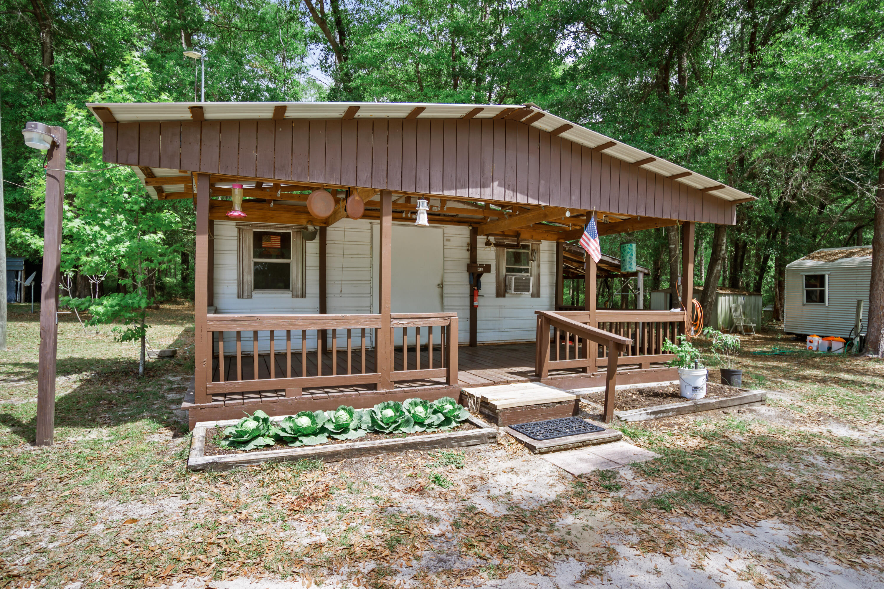 15766 Northeast Bob Sanders Road Hosford, FL 32334 - Photo 25 of 33 a view of a chair and table in backyard of the house