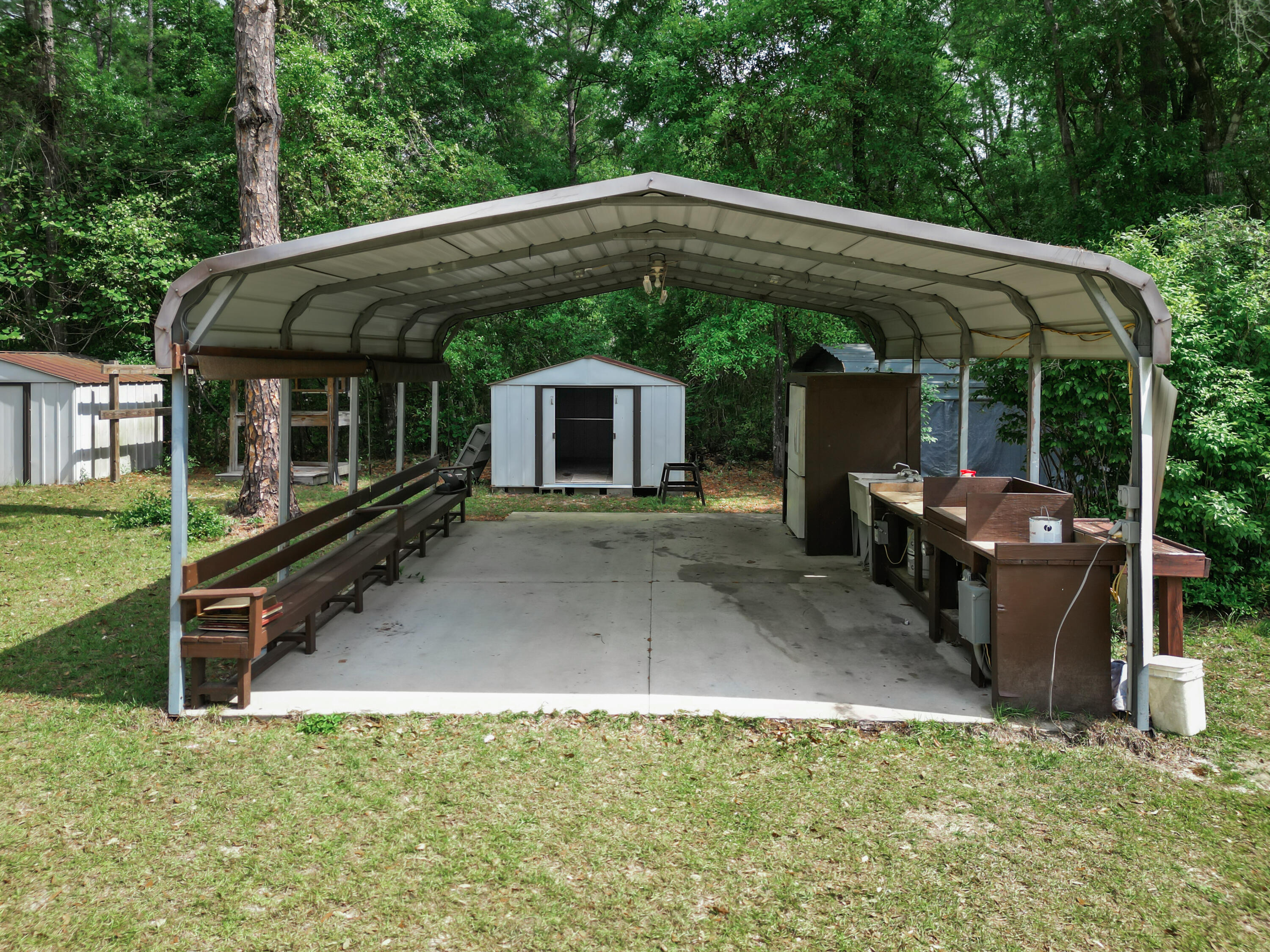 15766 Northeast Bob Sanders Road Hosford, FL 32334 - Photo 27 of 33 a backyard of a house with yard barbeque oven and outdoor seating