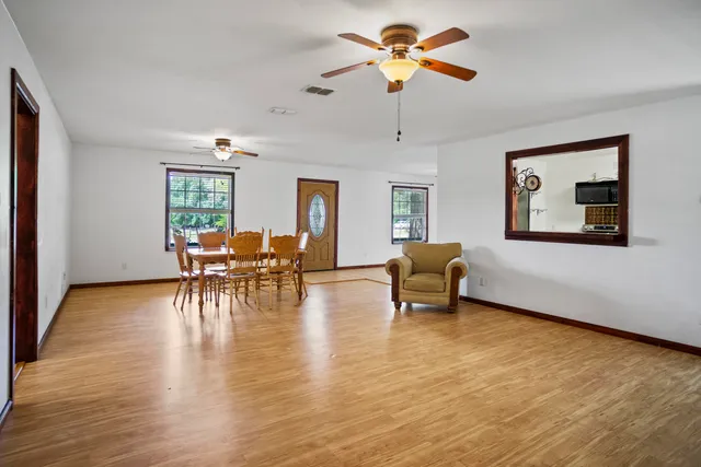 a living room with furniture and a wooden floor