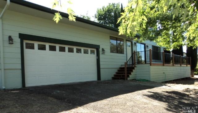 19338 Stonegate Road Hidden Valley Lake, CA 95467 - Photo 1 of 1 a front view of a house with a yard