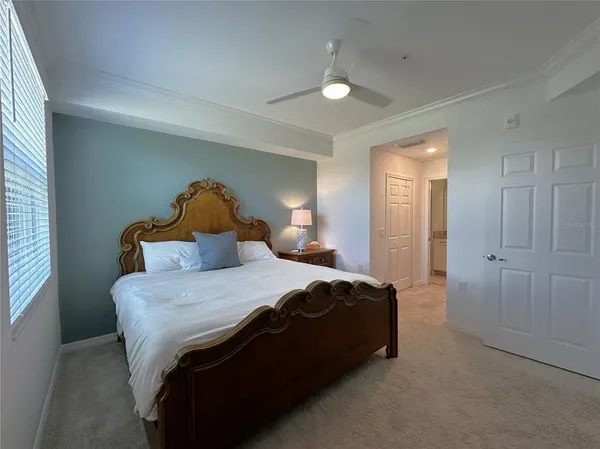 a bathroom with a granite countertop sink a toilet a mirror and shower