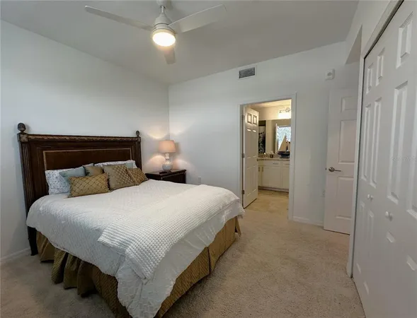 a bathroom with a granite countertop double vanity sink and a mirror