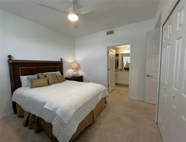 a bathroom with a granite countertop double vanity sink and a mirror