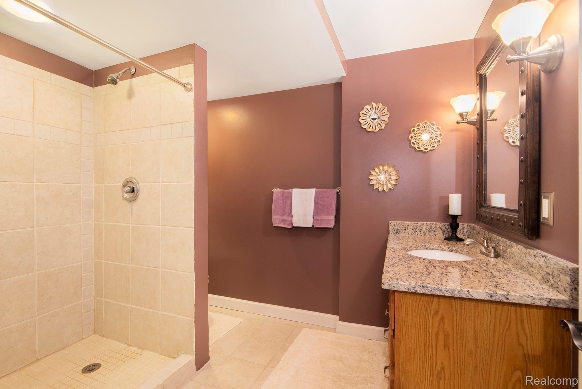 2524 Ravine Side North Howell, MI 48843 - Photo 27 of 31 full bath with tiled shower and granite counter