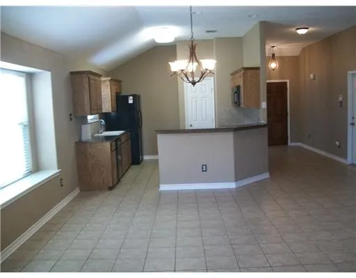 a view of a kitchen with a sink and cabinet