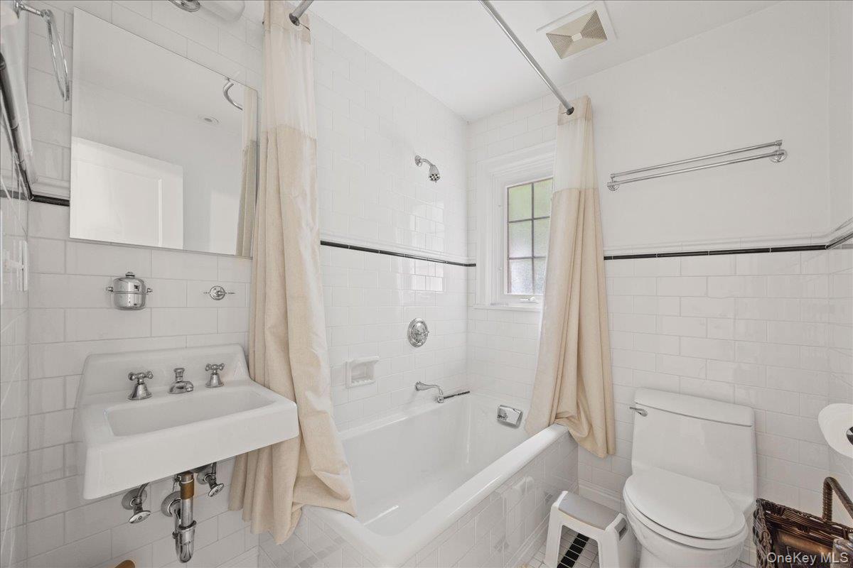 311 Lyncroft Road New Rochelle, NY 10804 - Photo 28 of 39 a white toilet sitting next to a bath tub