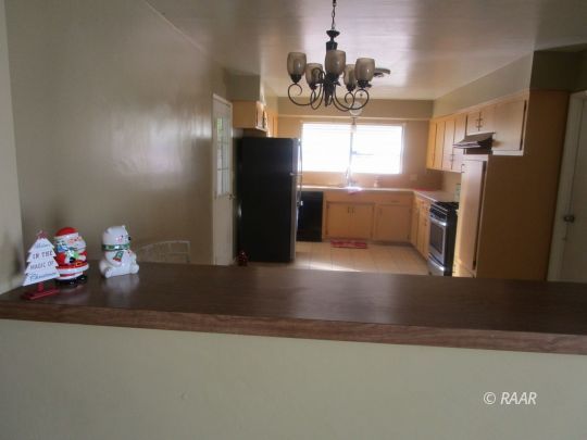 232 South Silver Ridge Street Ridgecrest, CA 93555 - Photo 10 of 19 a kitchen with refrigerator and window