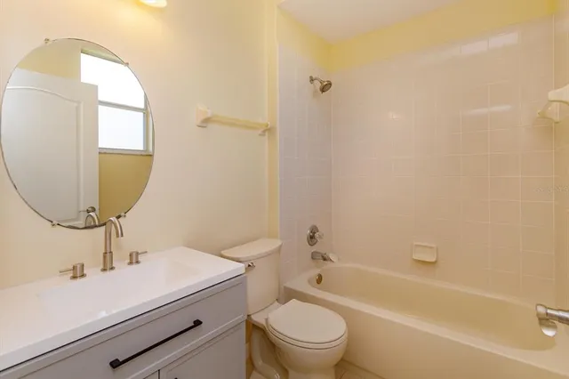 a view of a kitchen with wooden floor and a window